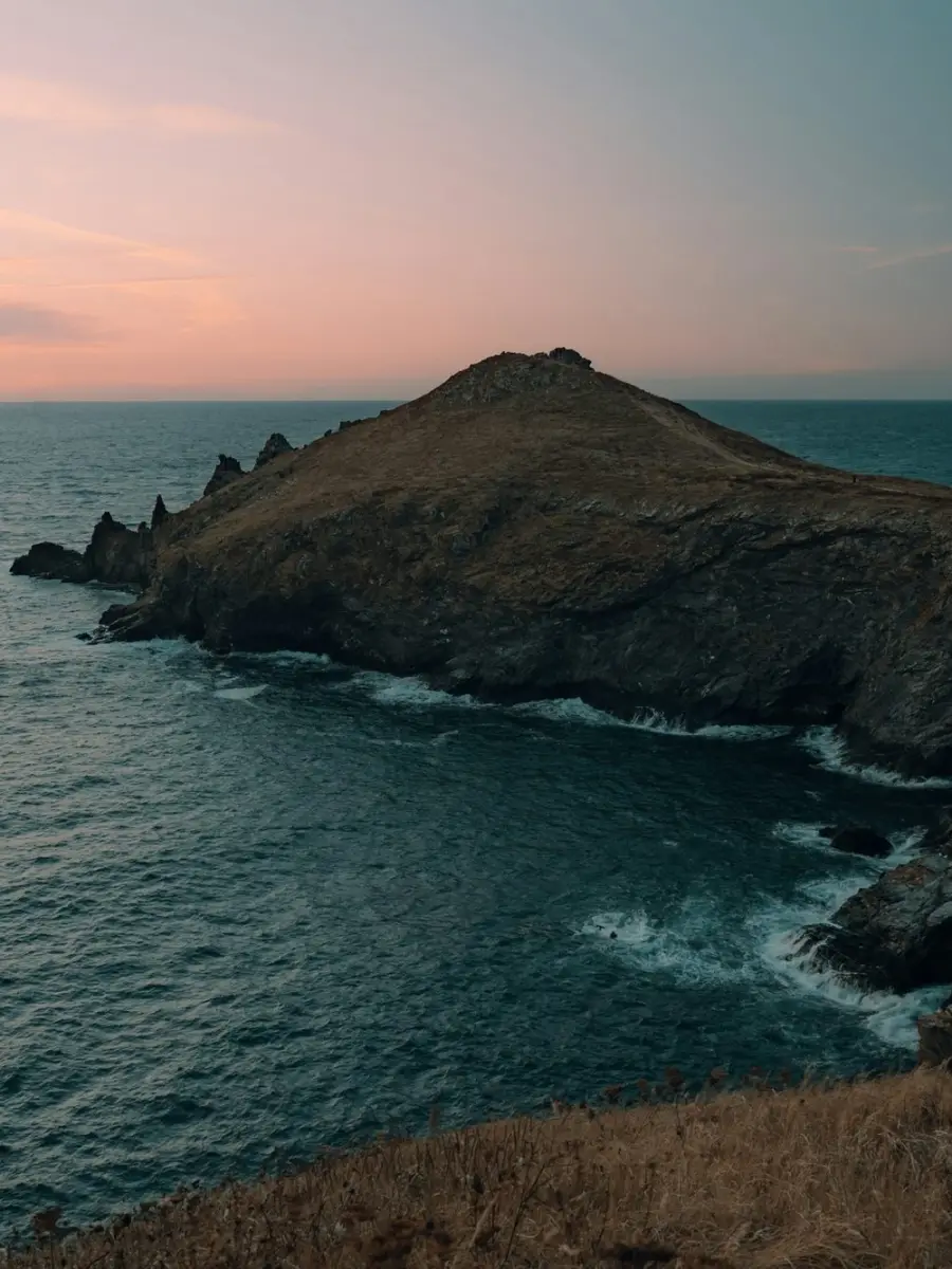 Côte sauvage et promontoire dans la lumière dorée du soir